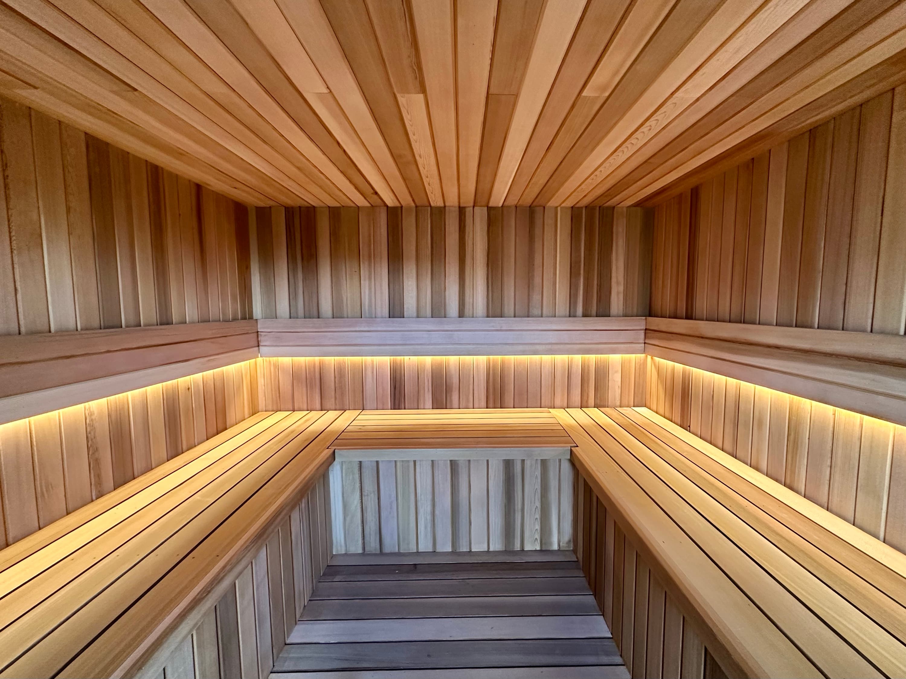 Warm lamplight inside the wood-fired sauna